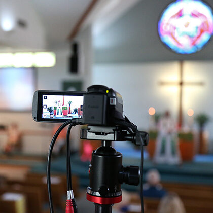 A video camera records worship services