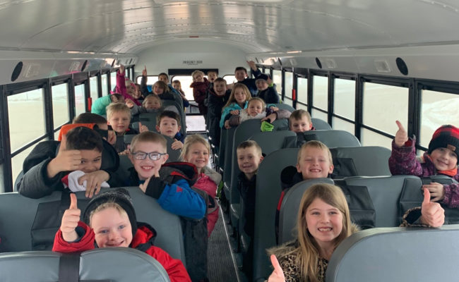 Students smile while on the new EmBe bus