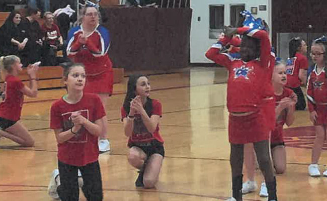 Cheerleaders rally fans.